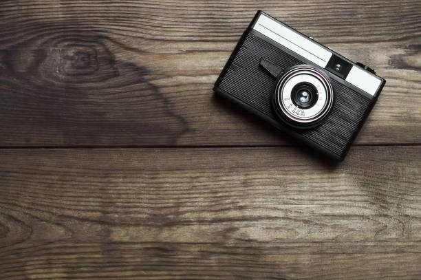 Classic film camera on wooden background. stock photo
