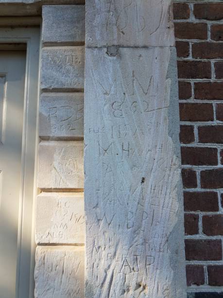 istock engravings of letters on white or grey cement on building 1169858674