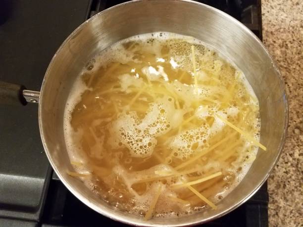 istock spaghetti cooking in boiling water in pot on stove 1169861679