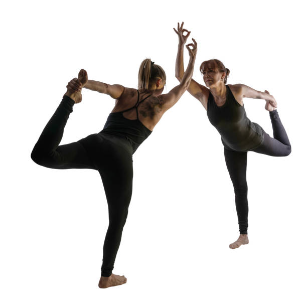 istock Two Woman doing yoga, white background 1169862600