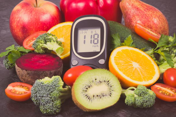istock Glucose meter with sugar level and fruits with vegetables, nutritious dessert containing minerals and vitamins for diabetic 1169863695