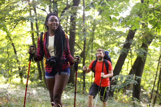 istock Young couple walking in a forest 1169867271
