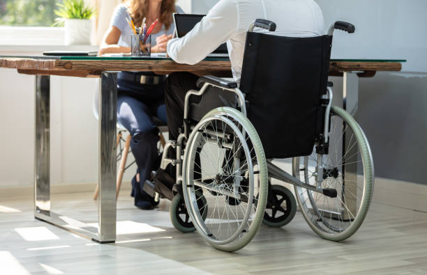 istock Disabled Businessman Working On Laptop 1169870148