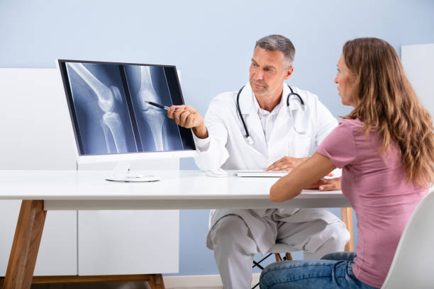 istock Doctor Showing Knee X-ray To Patient 1169870600