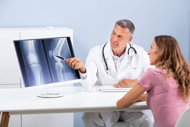 istock Doctor Showing Knee X-ray To Patient 1169870645