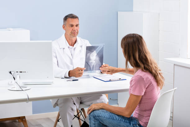 istock Doctor And Patient Checking Knee X-ray 1169870668