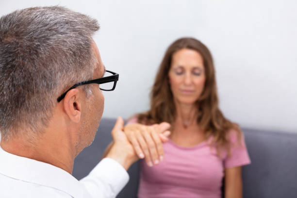 istock Hypnotherapist Holding Woman Hand During Hypnotherapy 1169870775