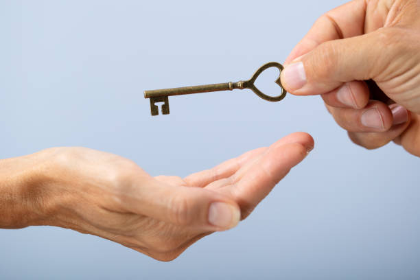 istock Person Hand Giving Home Key To A Client 1169871498