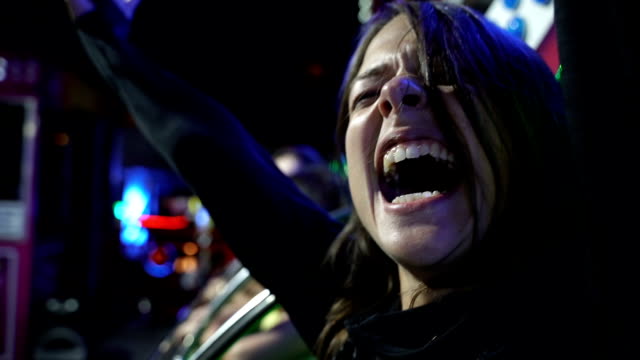 Beautiful girl screaming an laughing in amusement park ride