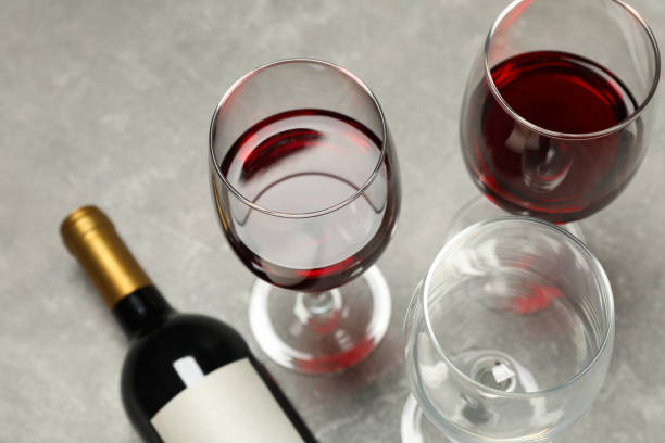istock Flat lay composition with bottle and glasses of wine on grey background, copy space 1169874478
