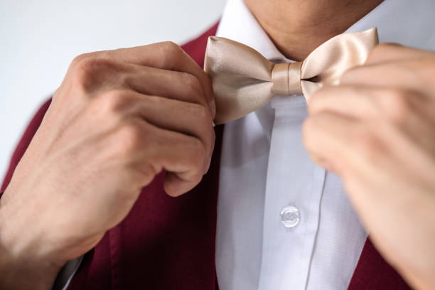 istock Young man wearing red suit with bow tie 1169874846