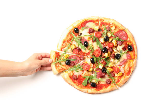 女性の手は、白い背景に隔離されたピザの一部を取ります - foods and drinks isolated on white basil cooked ストックフォトと画像