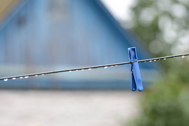 Clothespins attached to a utility rope against a blurred background, offering ample copy space.