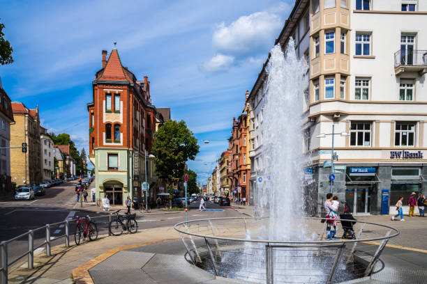 Squirting fountain at marienplatz square in inner city of stuttgart where historical houses and cafes attract many people stock photo