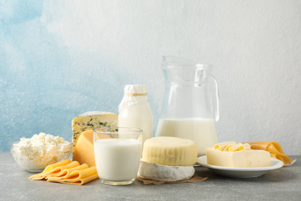 istock Dairy products on grey table against blue background, copy space 1169880131