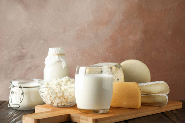 istock Fresh dairy products and cutting board on wooden background, copy space 1169880317