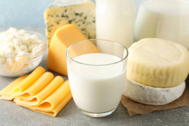istock Dairy products on grey table against blue background, space for text 1169880369