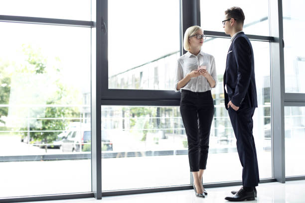 istock Coworkers talking in their office 1169881011