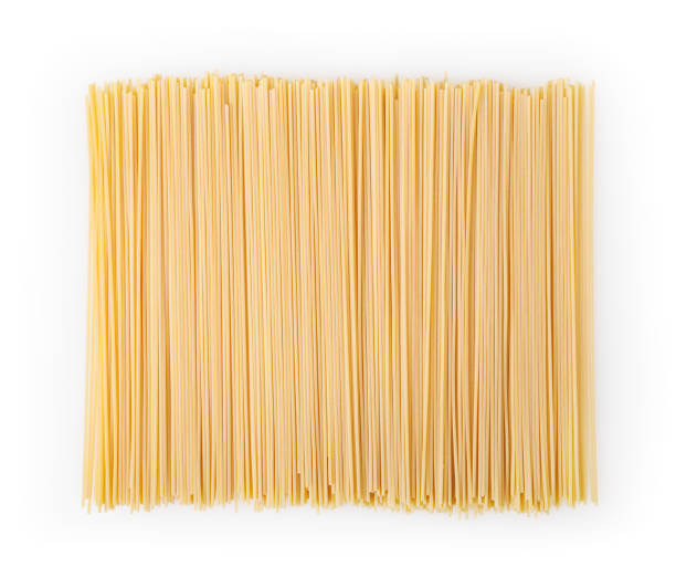 istock Uncooked spaghetti isolated on white background with clipping path 1169887395