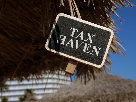 Tax haven sign on wooden plate.