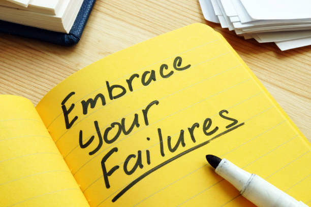 istock Embrace your failures written by pen on the page. 1169888578
