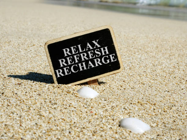 istock Relax refresh recharge sign on a beach. 1169889121