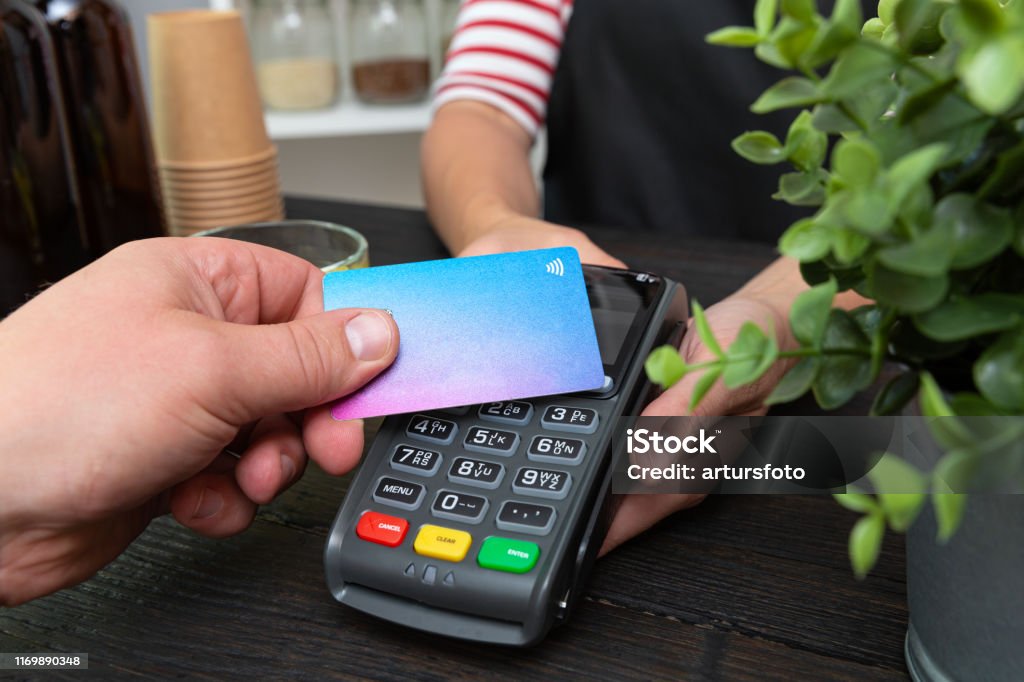 Customer making wireless or contactless payment using credit card Paying Stock Photo