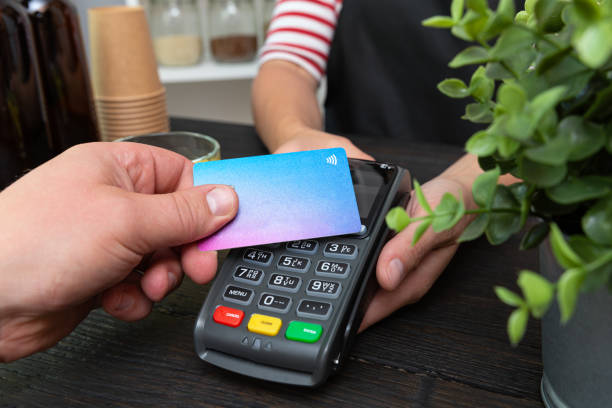 Customer making wireless or contactless payment using credit card Customer making wireless or contactless payment using credit card point of sale stock pictures, royalty-free photos & images