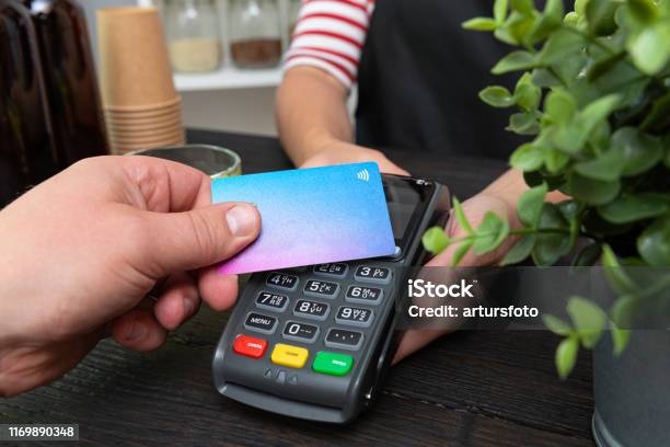 Customer Making Wireless Or Contactless Payment Using Credit Card Stock Photo - Download Image Now