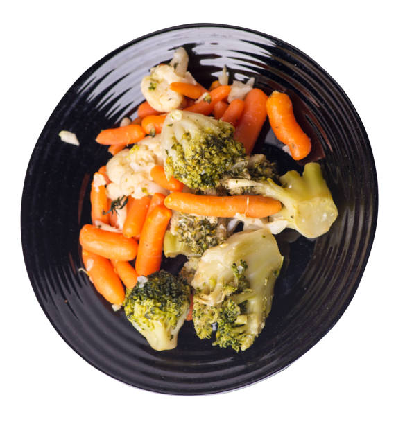istock provencal vegetables on a plate.grilled vegetables on a plate isolated on white background.broccoli and carrots on a plate top view.healthy  food 1169894501