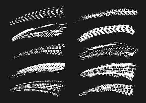 Motorcycle tire tracks vector illustration. Grunge automotive element useful for poster, print, flyer, book, booklet, brochure and leaflet design. Editable graphic set in white color isolated on a black background.