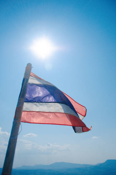 istock Thailand flag waving in the wind with beautiful blue sky and sunlight 1169899178