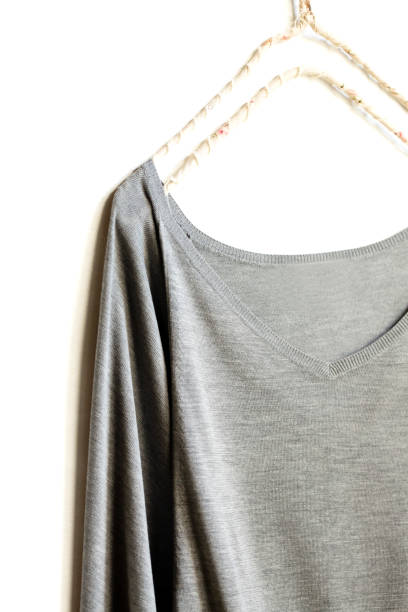 istock a cut sew or knit in grey hanging on clothes hanger on white background. 1169899547