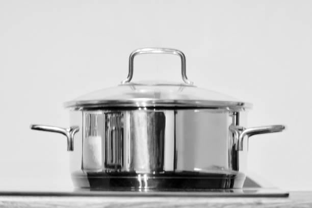 istock Blurred stainless steel cooking pot on the stove 1169900630