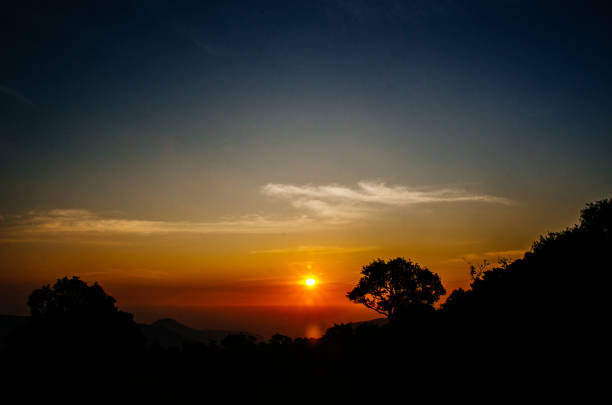 istock Panorama of rising sunbeams over mountains 1169901431