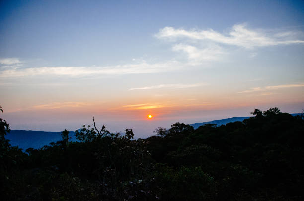 istock Panorama of rising sunbeams over mountains 1169901437