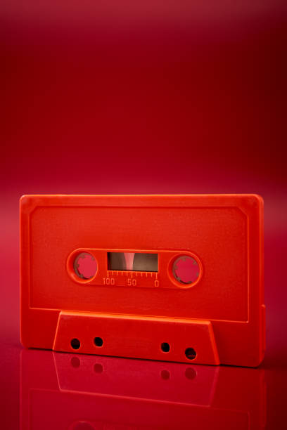 istock orange audio cassette on the dark red background 1169906609