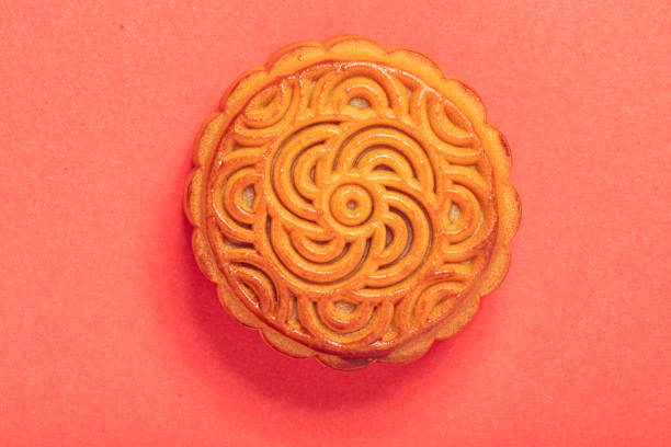 istock Chinese mooncake isolated on red background by top view. 1169909399