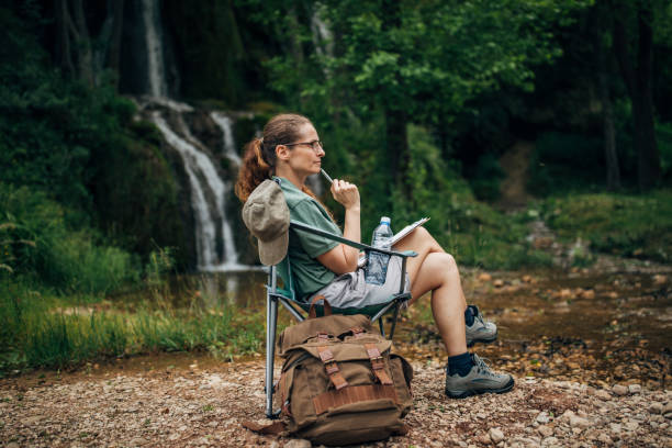 istock Woman biologist sitting in nature 1169909645