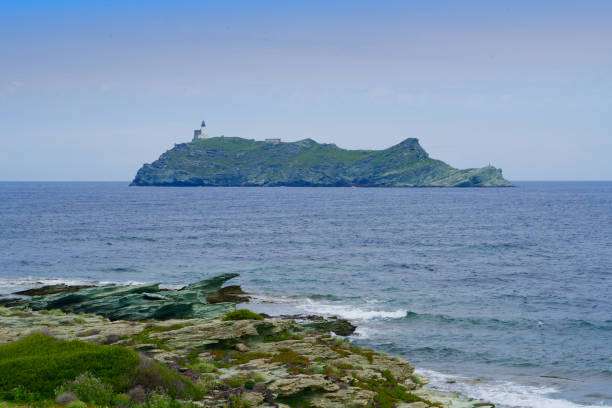 istock small island in the ocean with a tower 1169912238