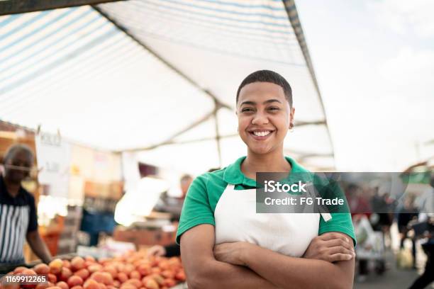 Portrait Of A Young Woman Working In A Street Market Stock Photo - Download Image Now