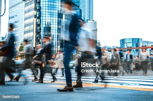 istock Blurred group of business people commuting on the streets of Japan 1169912369