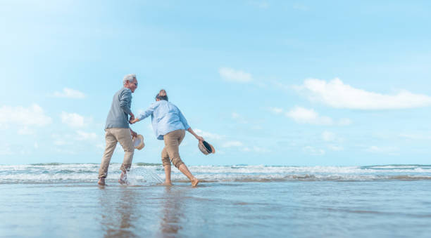 istock Mature mother and son dancing on the beach 1169915024