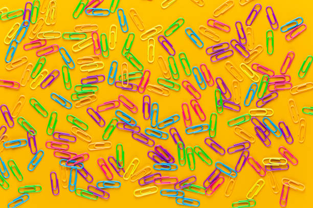 istock Paper color clip notebook on yellow background. Flat lay. 1169920990