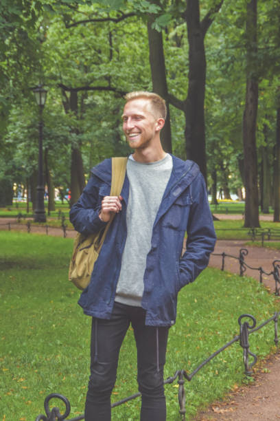 istock young man with a beard in a Park among the trees 1169921299