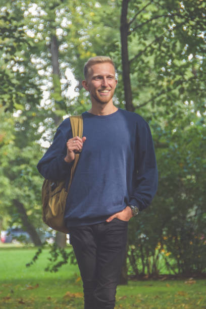 istock young man with a beard in a Park among the trees 1169921463