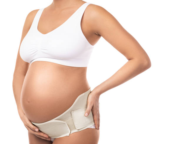 belly of pregnant woman with elastic maternity  band - waistband imagens e fotografias de stock