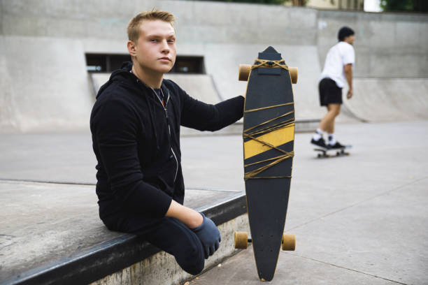 istock Motivated handicapped  guy with a longboard in the skatepark 1169924154
