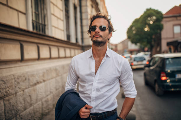 istock Modern gentleman standing on the sidewalk 1169925246