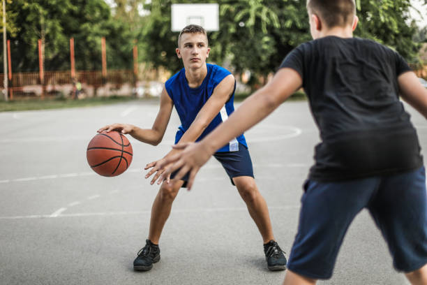 istock Playing Basketball Outdoors 1169926625